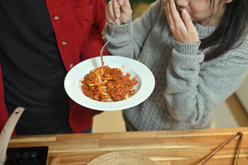 Cropped shot couple sharing a delicious homemade pasta dish