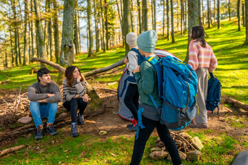 Obraz premium Brothers arriving where their parents are sitting during camping weekend