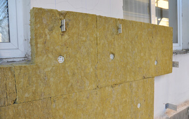 External solid wall insulation with mineral wool. House facade renovation with mineral wool...