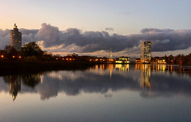 Naklejka premium Tartu city skyline reflected in the Anne lake during sunset, Tartumaa, Estonia, November 2020