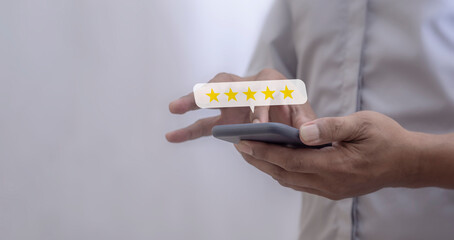 Customer Review, Young Man hand using smartphone mobile with five star to review and give 5 stars with very good results in service, Good review 5 star rating choice feedback