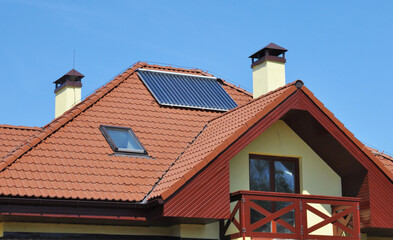 Modern house rooftop with residential lightning protection, attic skylight, solar water heater,...