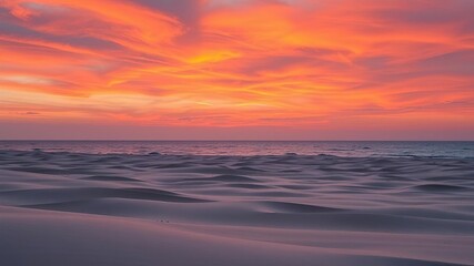 A vibrant orange hue permeates the sky as day transitions to night, illuminating a vast expanse of rolling sand and shimmering water, ocean, nature, dunes