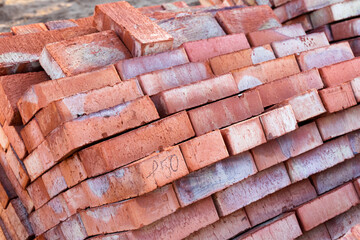 Racks with brick. Masonry, stonework. Several pallets with concrete brick stacked on top of each other in depot. bricks on pallets