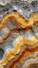 Obraz premium Close-up of beautifully patterned agate stone, showcasing vibrant orange, yellow, and gray layers that create a striking natural design.