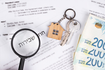 Rental or Residential Lease agreement, magnifying glass, Shekels money cash, and house keys. Short and long term rentals, housing searching crisis in Israel, signing contract, and rising prices.