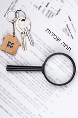 Rental or Residential Lease agreement, magnifying glass and house keys. Short and long term rentals, housing searching crisis in Israel, signing contract, and rising prices.