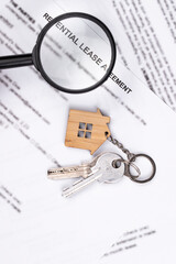 Rental or Residential Lease agreement contract, magnifying glass, and house keys. Short and long...