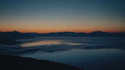 Fototapeta premium Spectacular Photograph of Mountains with Fog at Sunrise Showcasing Dramatic Sky and Tranquil Atmosphere