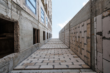 Emerging Structure: A Glimpse of Urban Transformation, Where Concrete Embraces Brick in the Dance of Architectural Progress.