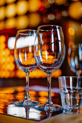 Reflections of Taste: A trio of glasses—two elegant wine vessels and a crisp water glass—awaiting the perfect toast on a sunlit ta