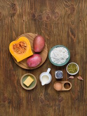 Prepared ingredients for pumpkin gnocchi or dumplings on brown wooden background. Recipes pumpkin.