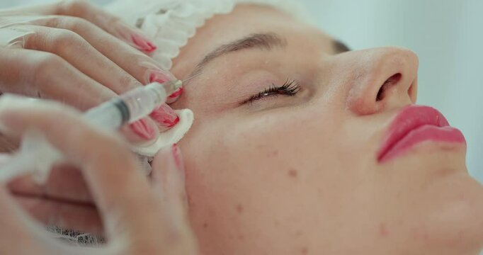 Beautician doctor makes injections into the skin of the face of a young beautiful woman. Face mesotherapy procedure in a beauty salon. Mesotherapy, biorevitalization.