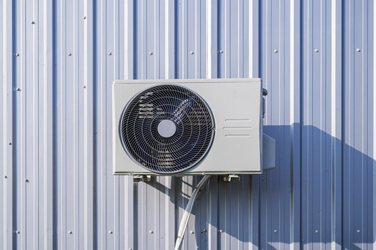 Multi-split outdoor air conditioner units on metallic wall
