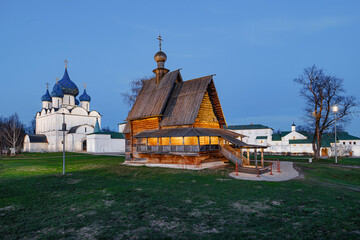 Fototapeta premium Sanctuary of Timeless Faith: A Wooden Church Embraced by the Majestic Stone Cathedral Beyond