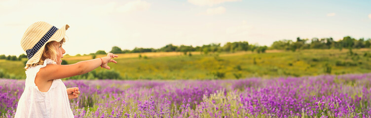 Child girl in lavender field. Selective focus.
