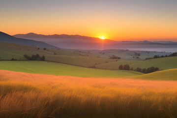 Naklejka premium A vibrant sunset paints the sky with hues of orange, yellow, and pink, casting a warm glow over rolling hills and a lush, green meadow. The sun dips below the horizon, leaving a trail of light across 