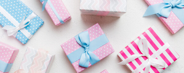 A lot of Christmas gift boxes in colored paper decorated on table, Top view close up. Many present New Year gift