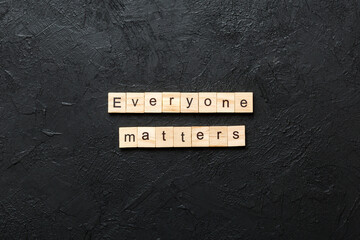 Everyone matters word written on wood block. Ever yone matterstext on cement table for your desing, Top view concept