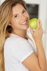 young happy woman eating apple