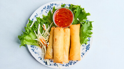 Crispy spring rolls filled with savory vegetables or meat, deep-fried to golden perfection. A popular appetizer served with a sweet and sour dipping sauce, perfect for any occasion.