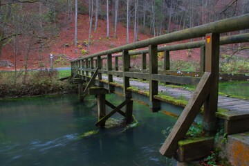 old wooden bridge with moss across the pegnitz river countryside of nuremberger land bavaria