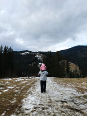 Family hike through scenic snowy mountain landscape