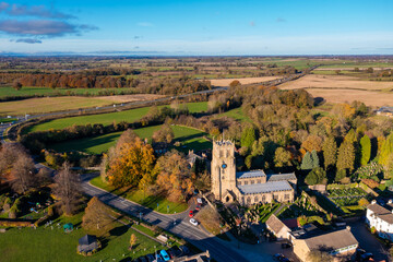 Aerial photo of the beautiful town of Bedale which is a market town in the Hambleton former district of North Yorkshire showing the beautiful town, church and motorway in the autumn time