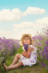 Child girl in lavender field. Selective focus.