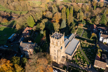 Aerial photo of the beautiful British town of Bedale which is a market town in the Hambleton former district of North Yorkshire in the UK showing a church building and cemetery in the Autumn time
