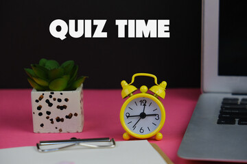 the words Quiz Time beside mini alarm clock on a plain background. the concept of answering quizzes...