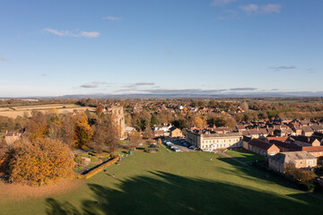 Aerial photo of the beautiful town of Bedale which is a market town in the Hambleton former district of North Yorkshire showing the beautiful town, church and public park in the autumn time