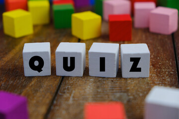 the words Quiz on wooden blocks. the concept of answering quizzes or quiz games. the concept of...