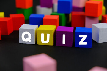 the words Quiz on wooden blocks. the concept of answering quizzes or quiz games. the concept of...