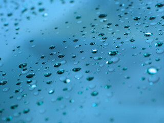 Close-Up of Water Droplets on Blue Surface with Gradient Effect