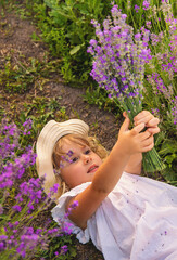Child girl in lavender field. Selective focus.
