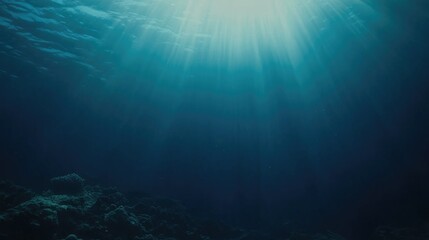 Fototapeta premium Tranquil underwater scene showcasing a beautiful blue gradient with gentle light rays filtering through the blue depths, creating a peaceful ambiance.