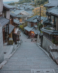 Fototapeta premium A serene Kyoto street at dawn, bathed in soft light, showcasing traditional Japanese charm and calm beauty.
