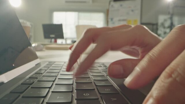 Macro close up of Unknown woman hands typing on computer keyboard in office. Dolly shot fingers pressing buttons on laptop. Programming, text chat online messaging and send emails marketing business.