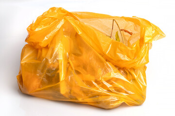 Bio organic trash sorted in yellow plastic bag for composting or recycling isolated on white...