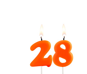 Lit birthday candle - Candle number 28 on white background.