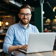 Young entrepreneur working on a laptop in a cozy coffee shop, smiling and looking determined