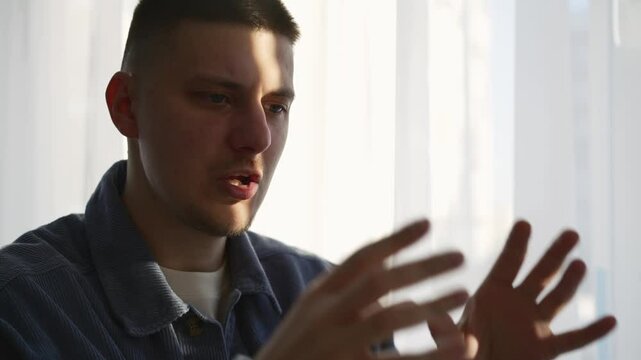 A man talks about himself, Portrait of an attractive man in the office, explaining something, gesturing