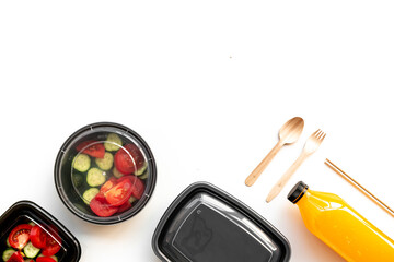 Healthy food delivery in takeaway boxes with and disposable cutlery, top view