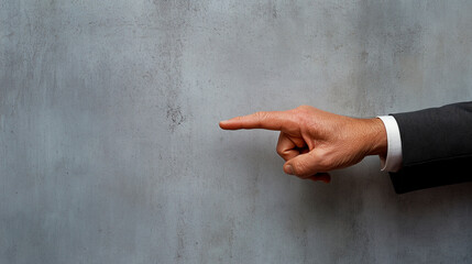 Businessman hand with pointing finger on a gray background. Copy space