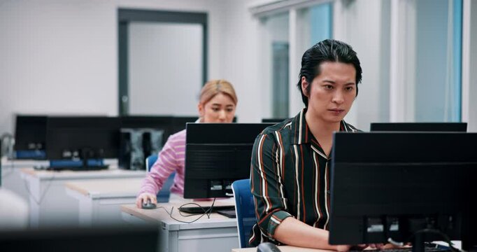 Training, center and group of business people at computer for research, growth or development in office. Technology, Japanese men and women in coworking space for online course, productivity or seo