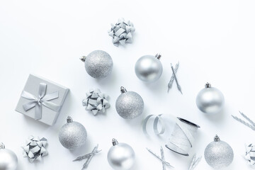 Silver colored Christmas and New Year decorations on white background, top view