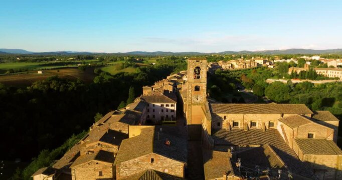 The Bell Tower Of The Church of St. Catherine At Colle di Val d'Elsa At Sunrise In Tuscany, Italy. Aerial Drone Shot