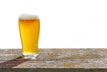 A glass of cold beer placed on a table