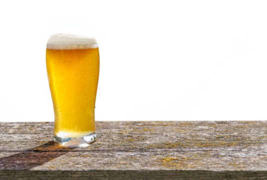 A glass of cold beer placed on a table